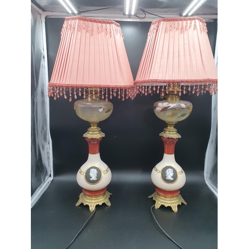 701 - A pair of converted Oil Lamps with floral painted reservoirs, brass mounted baluster bases with port... 