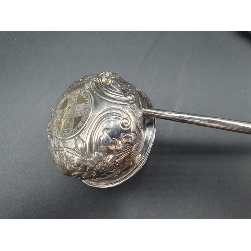 125 - A Georgian Toddy Ladle with floral embossed and coin inset bowl, another plain with coin inset bowl,... 