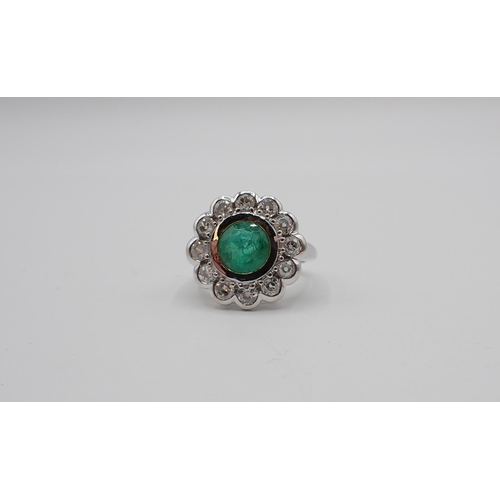 168 - An Emerald and Diamond Cluster Ring rubover-set round emerald within a frame of twelve old-cut diamo... 