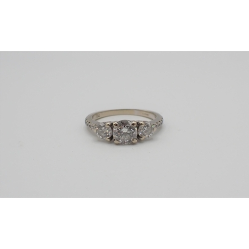 169 - A Diamond three stone Ring claw-set brilliant-cut stone, est 0.65cts, between two smaller stones, fu... 