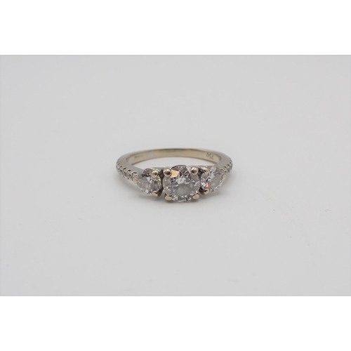 169 - A Diamond three stone Ring claw-set brilliant-cut stone, est 0.65cts, between two smaller stones, fu... 