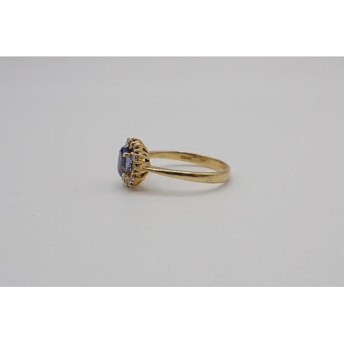 172 - A Sapphire and Diamond Cluster Ring claw-set oval-cut sapphire within a frame of twelve brilliant-cu... 