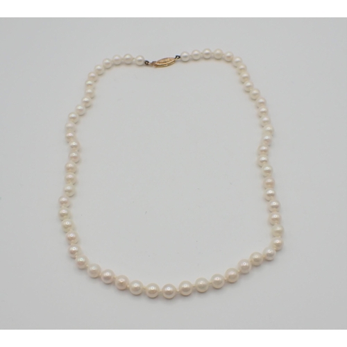 223 - A string of Cultured Pearls on clasp stamped 375