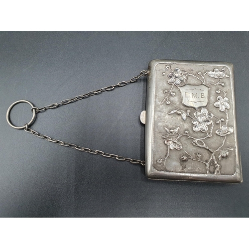 117 - A Chinese white metal Purse decorated bamboo and flowering prunus, engraved initials, with chain and... 