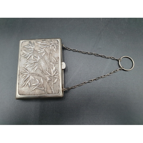 117 - A Chinese white metal Purse decorated bamboo and flowering prunus, engraved initials, with chain and... 