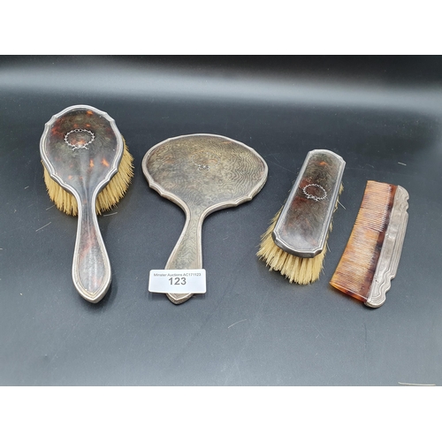 123 - Two silver and tortoiseshell mounted Brushes and a Mirror, Birmingham 1918, and a similar Comb