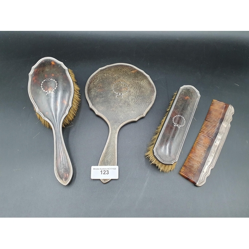 123 - Two silver and tortoiseshell mounted Brushes and a Mirror, Birmingham 1918, and a similar Comb