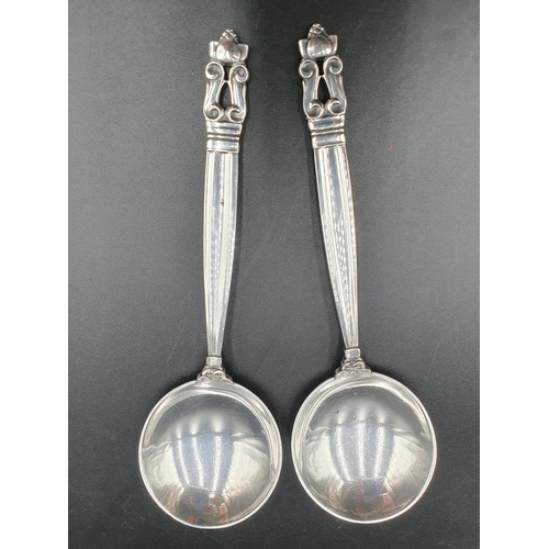 132 - A pair of Georg Jenson sterling silver Spoons with acorn finials, 6in.