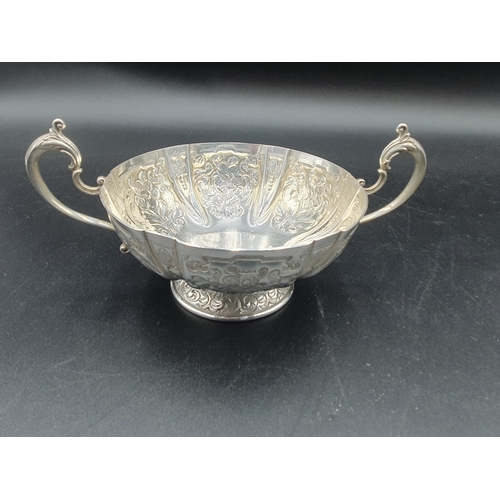 138 - An Elizabeth II Limited Edition Silver Jubilee two-handled Bowl with floral panels on pedestal base,... 