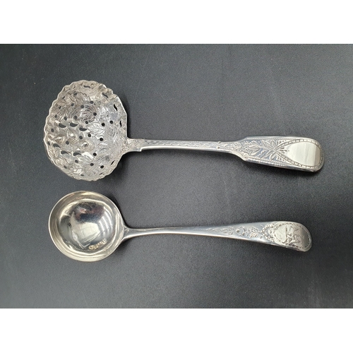 148 - A George IV silver Sifting Ladle fiddle pattern with leafage engraving, floral embossed bowl, London... 