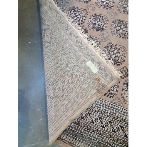 291 - A large bordered carpet, of multi-bordered design with rows of medallions on a beige ground, 12ft x ... 