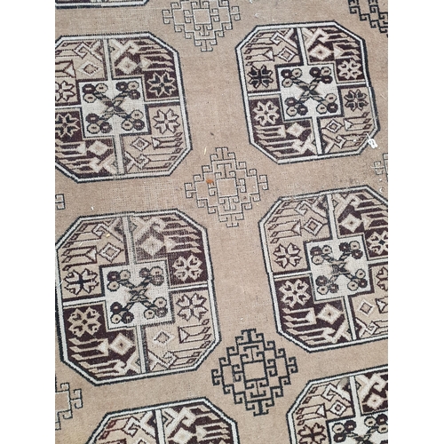 291 - A large bordered carpet, of multi-bordered design with rows of medallions on a beige ground, 12ft x ... 