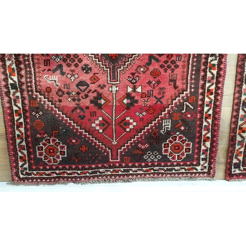 292 - A small Persian Rug, with stylised floral motifs on a red ground, 4ft 10in x 3ft 5in (R6)