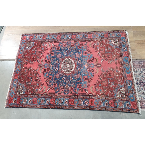 295 - A Persian Rug, the border decorated birds and flowers and with stylised floral designs on a red grou... 