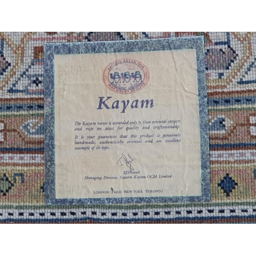 296 - A Kayam Rug, with multiple borders, the central green ground decorated repeating motifs, 7ft 9in x 5... 