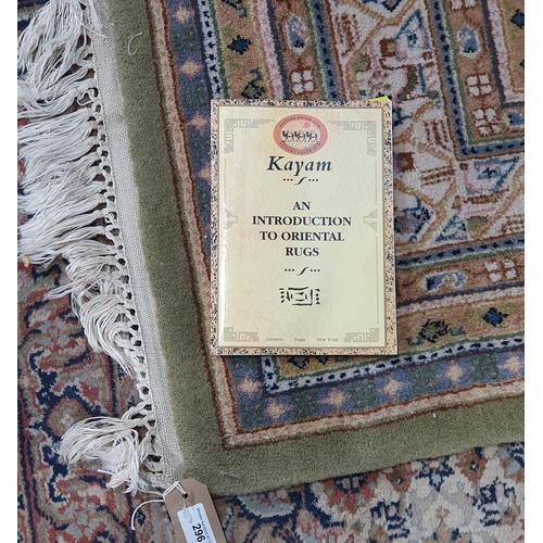 296 - A Kayam Rug, with multiple borders, the central green ground decorated repeating motifs, 7ft 9in x 5... 