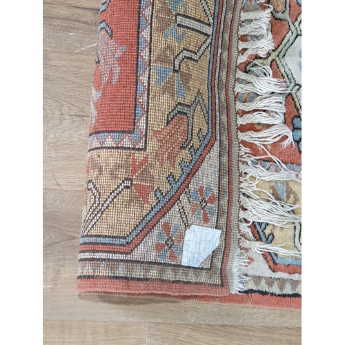 297 - A small Turkish wool Rug with three medallions on a red ground, 4ft 6in x 2ft 8in (R4/R5)