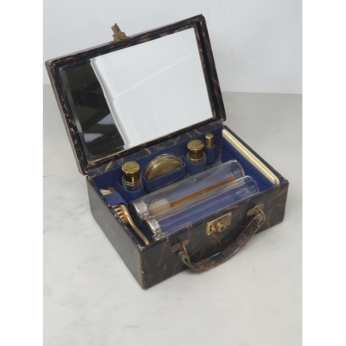 39 - A leather travelling Vanity Case with fitted interior and mirror within lid 8 1/2in W x 3 1/2in H