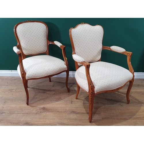 547 - Two French beech framed Elbow Chairs with cream upholstery raised on cabriole supports 2ft 10in H (R... 