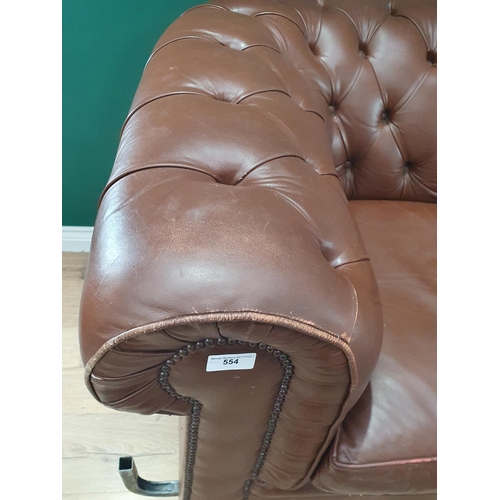 554 - A leather style button upholstered Chesterfield Settee, on turned supports, 7ft W approximately