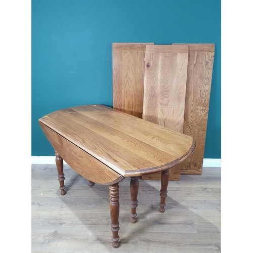 662 - A light oak extending Dining Table with drop leaves on turned supports, 7ft 6in W, (R8)