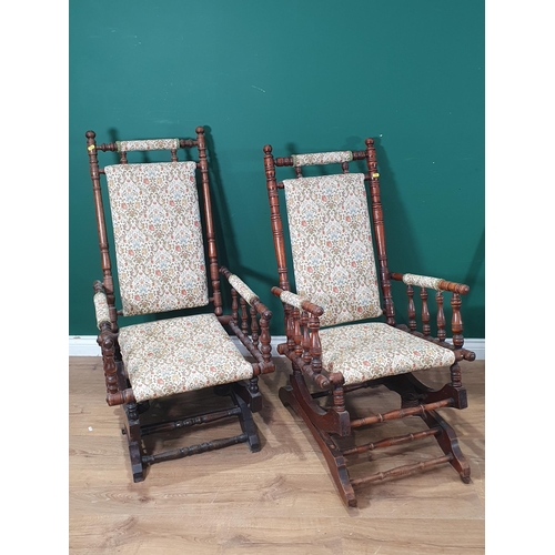 681 - Two American style upholstered Rocking Chairs on turned supports. (R8).