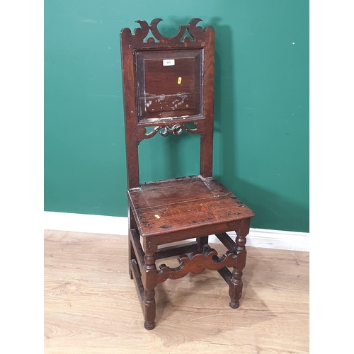 695 - An antique oak Hall Chair with panelled back, solid seat and scrolled front stretcher, A/F, (R8)