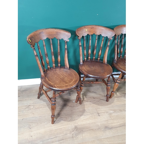 710 - A set of four elm seated Chairs with turned bar backs, circular seats and raised on turned supports ... 