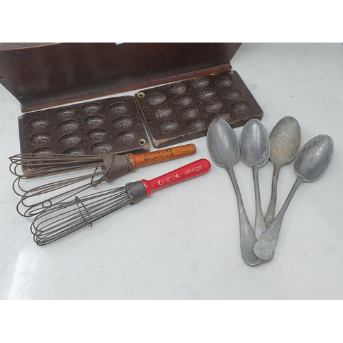 74 - An antique oak two division Cutlery Tray chocolate Egg Mould, a Cadbury's Whisk, a Bourneville Cocoa... 