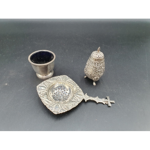 86 - An Edward VII silver octagonal Salt, Birmingham 1936, a Tea Strainer with windmill finial, an Easter... 