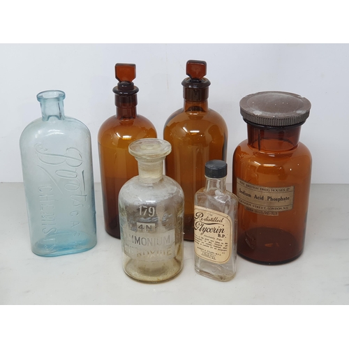 87 - Six glass Chemist's Bottles, six enamel Light Shades and an enamel Chamber Stick