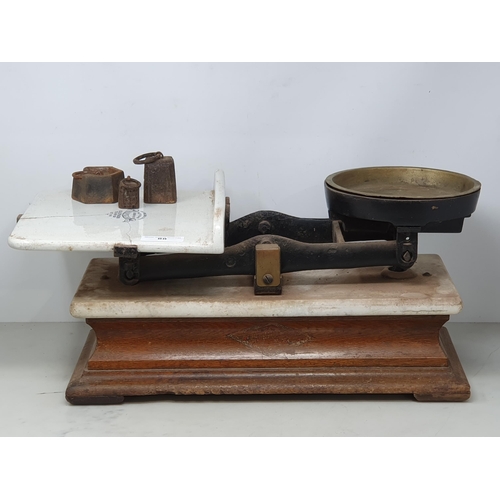 88 - A Victorian set of Scales by Hunt & Co. with three weights (ceramic plate A/F)