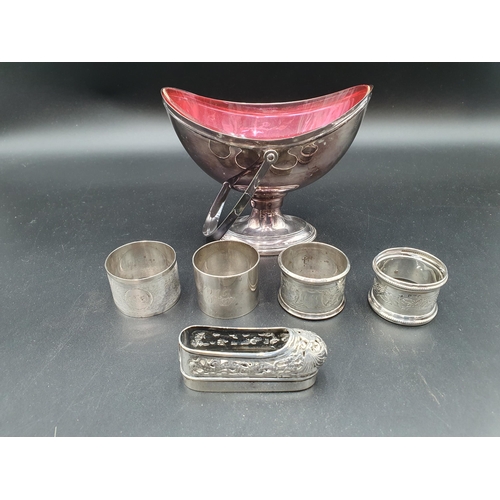 90 - Four various silver Napkin Rings, a Chinese silver Matchbox Holder in the form of a shoe with dragon... 