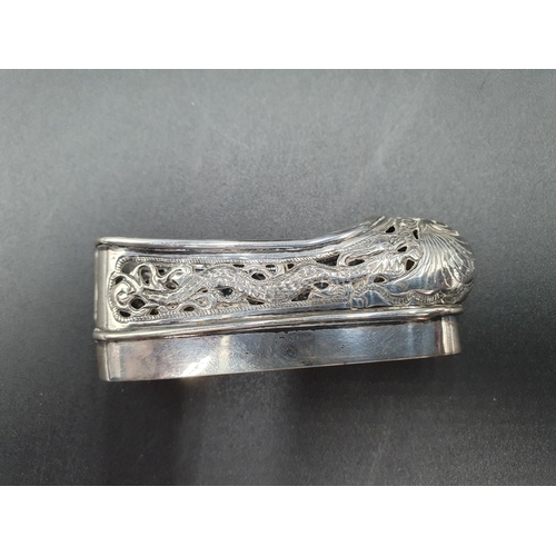 90 - Four various silver Napkin Rings, a Chinese silver Matchbox Holder in the form of a shoe with dragon... 