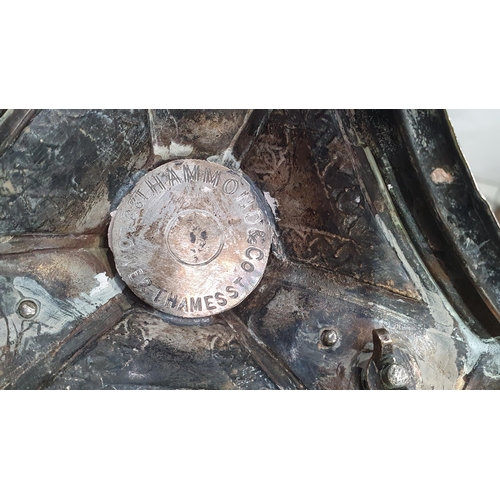 394 - A Silver Plated Tazza with turned column, with three winged Horse decorations, raised on stepped bas... 