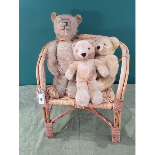 844 - An old plush Teddy Bear with jointed limbs, 20in L worn, two small Teddy Bears, all sat in a small c... 