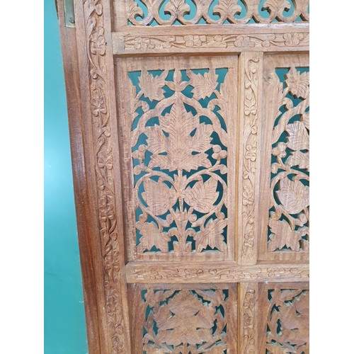 831 - An Eastern hardwood four-fold Screen with pierced and scrolled floral designs, 5ft 9in H (R11)