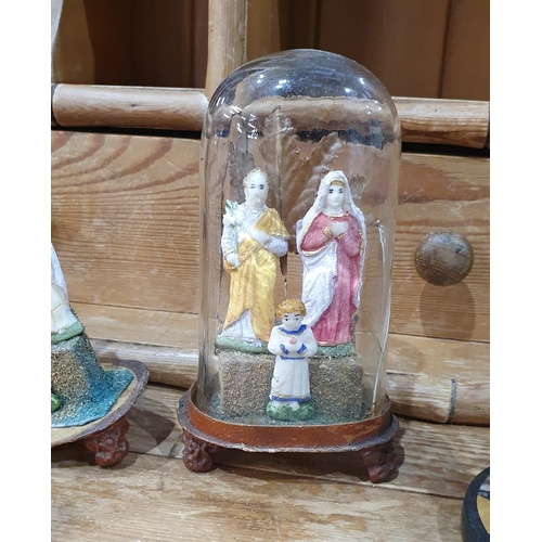 390 - A pair of resin painted religious groups under glass domes, 7in H, A/F, and a pair of black marble a... 