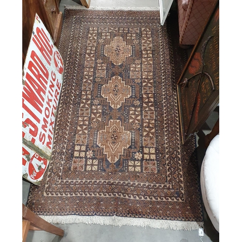 703 - A woollen Rug with three stylised flowers within multiple geometric borders 6ft L x 3ft 4in W (R3)