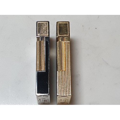 240 - Five Dupont Cigarette Lighters; three gold plated, one white metal, one black enamel