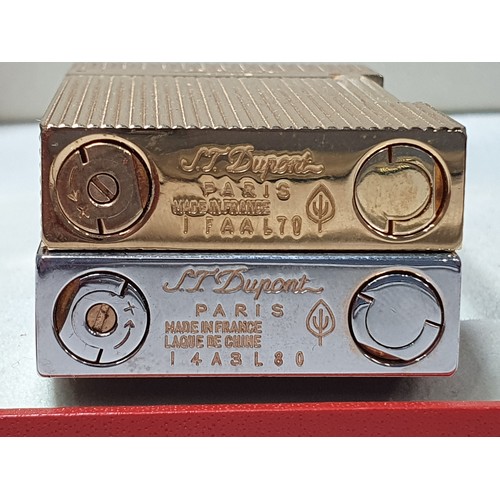 240 - Five Dupont Cigarette Lighters; three gold plated, one white metal, one black enamel