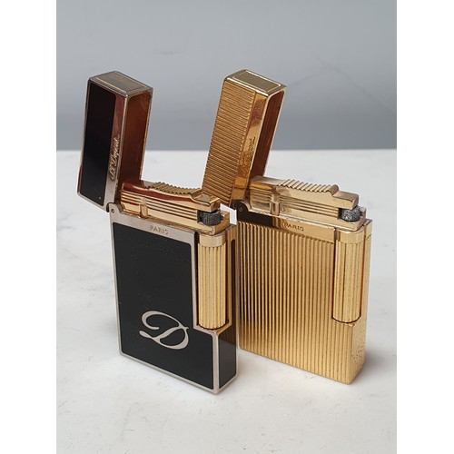 240 - Five Dupont Cigarette Lighters; three gold plated, one white metal, one black enamel