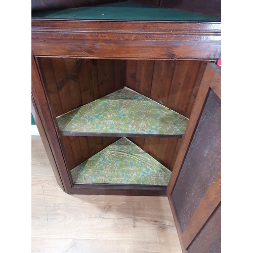 503 - An antique and later oak Standing Corner Cupboard, the top section with single glazed door enclosing... 