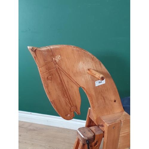 552 - A pine Rocking Horse with blue upholstered seat, 4ft 5in L, (R3).