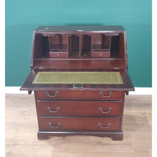 541 - A reproduction mahogany Bureau, the fall front enclosing pigeon hole and drawer interior and inset w... 