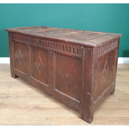 692 - An antique oak Coffer, the panelled lid above carved shaped frieze, with three panel front with carv... 