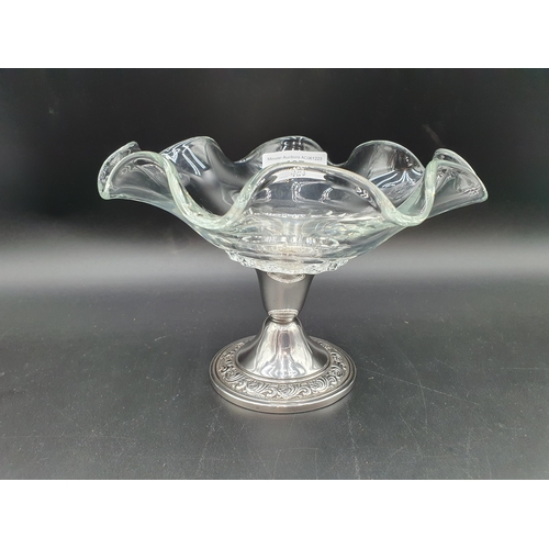 107 - A sterling silver mounted glass Comport with floral scroll frieze