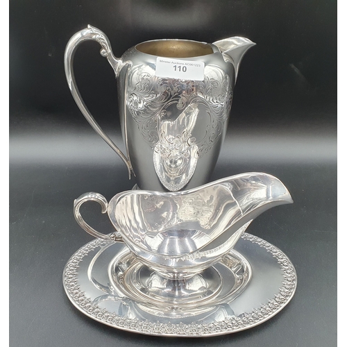 110 - A plated Jug with leafage scroll engraving and a Sauce Boat on Stand with floral border
