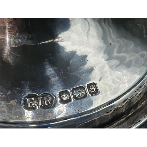 116 - A George V silver Capstan type circular Salt on scroll feet, Sheffield 1910, maker: FJR