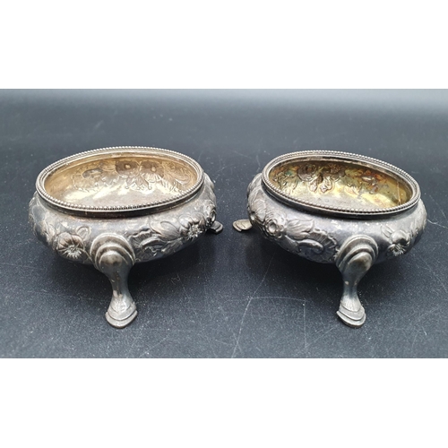 121 - Two pairs of Victorian silver Cauldron Salts floral embossed on hoof feet, London 1862/3